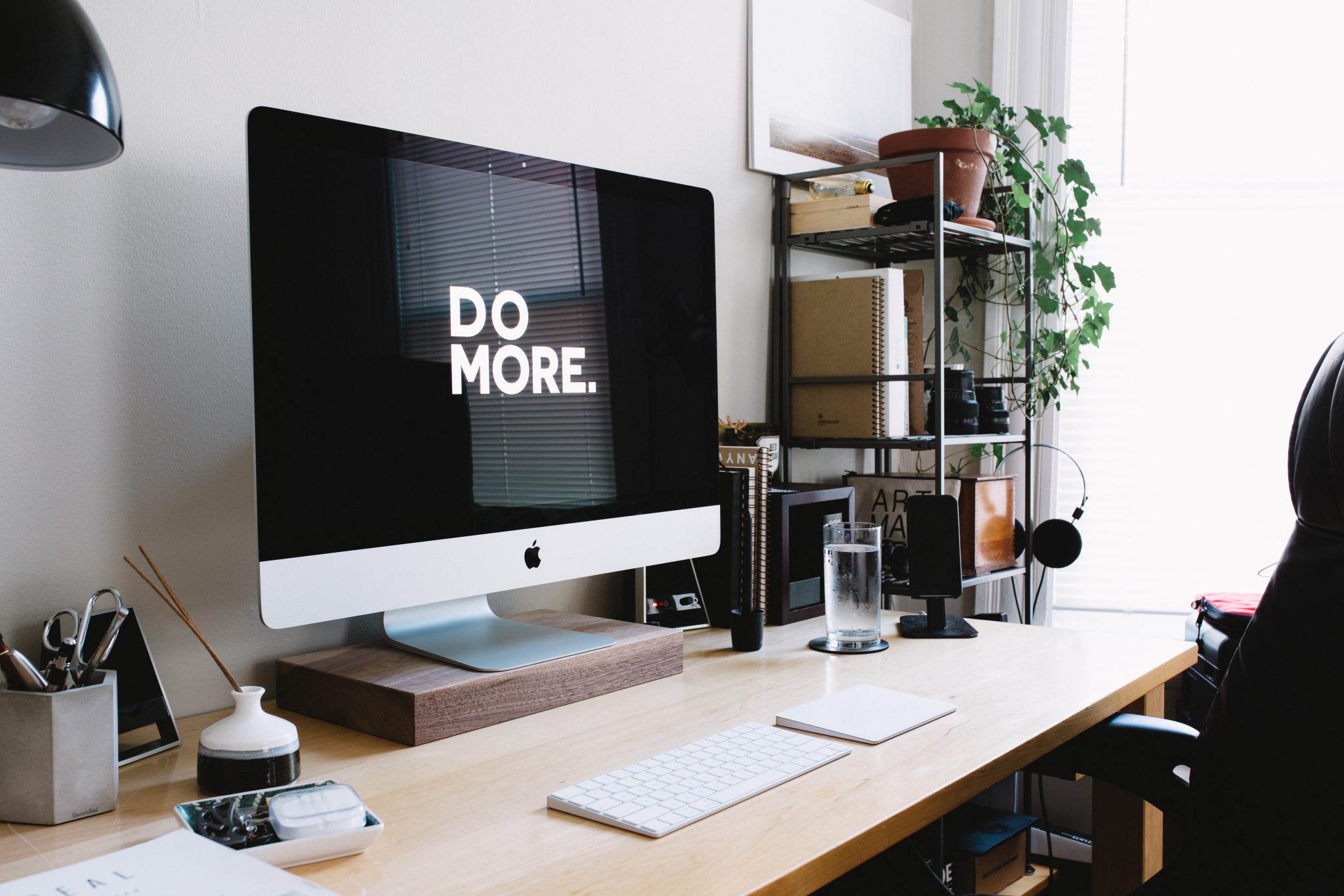 an iMac a wallpaper saying "Do More"