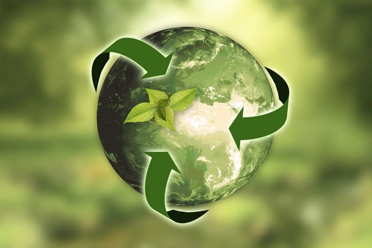 An illustration of a ball symbolizing green planet Earth with green arrows around it symbolizing sustainability