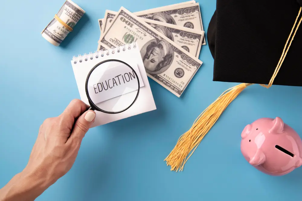 A hand holding a magnifying glass over a notebook with 'EDUCATION' text, symbolizing financial literacy efforts by credit unions.