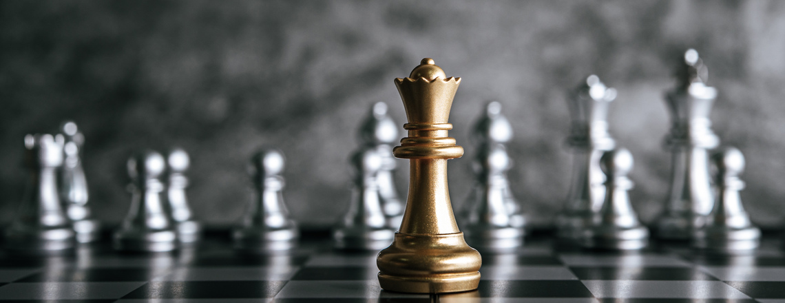  A gold chess piece standing prominently on a chessboard, symbolizing thought leadership.