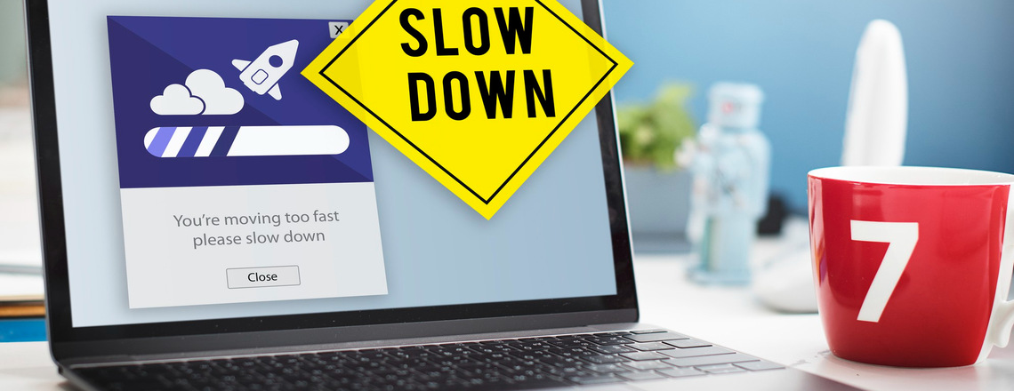 A laptop screen displaying a “slow down” message alongside a caution sign, symbolizing the need for a balanced approach in lead generation strategies.